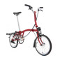 Preview: Der Freisteller eines roten Brompton Faltrades mit Gepäckträger ist seitlich von vorne zu sehen.