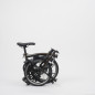Preview: Eingefaltetes Faltrad Brompton S6LD Black-Edition Black Lacquer vor weißem Hintergrund